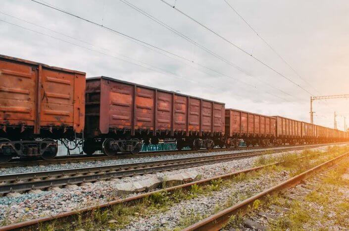 Freight wagons with solid cargo on the railway Steel gondola railcar
