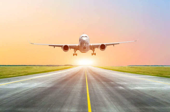 Midyear Market Concerns RESIDCO An airplane taking off in the sunset.